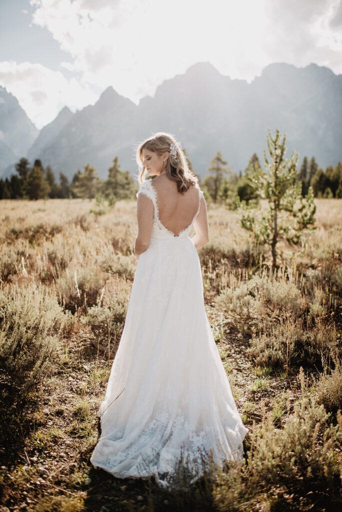 Jackson Hole Photographer captures bride looking over shoulder wearing wedding dress